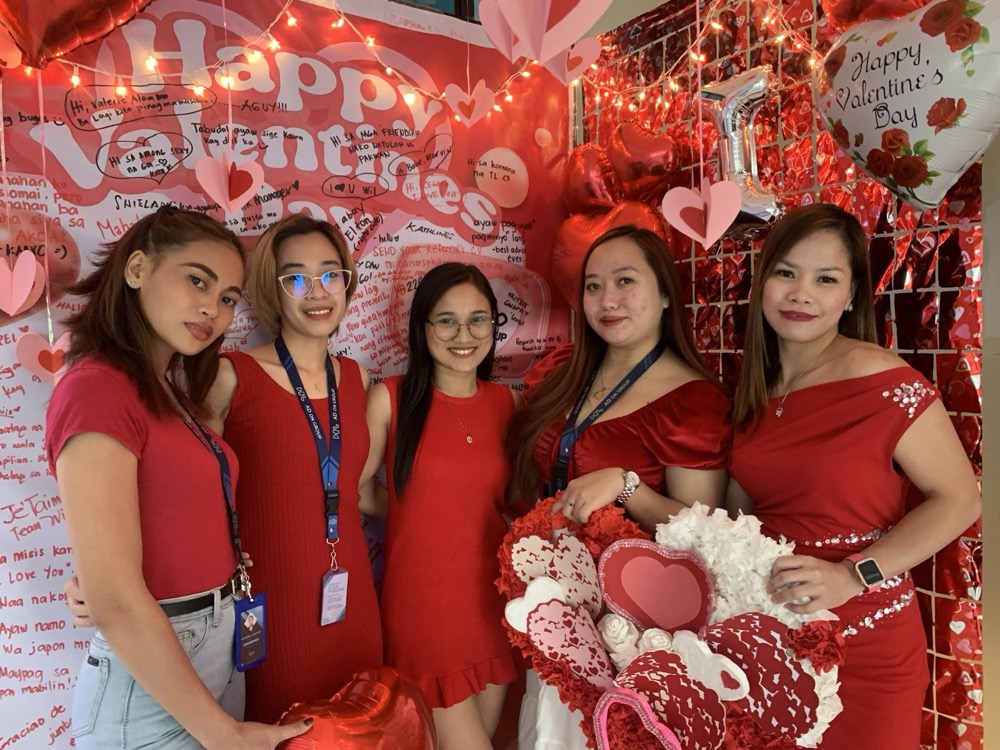 Large group of staff at an in-office Valentine's Day event