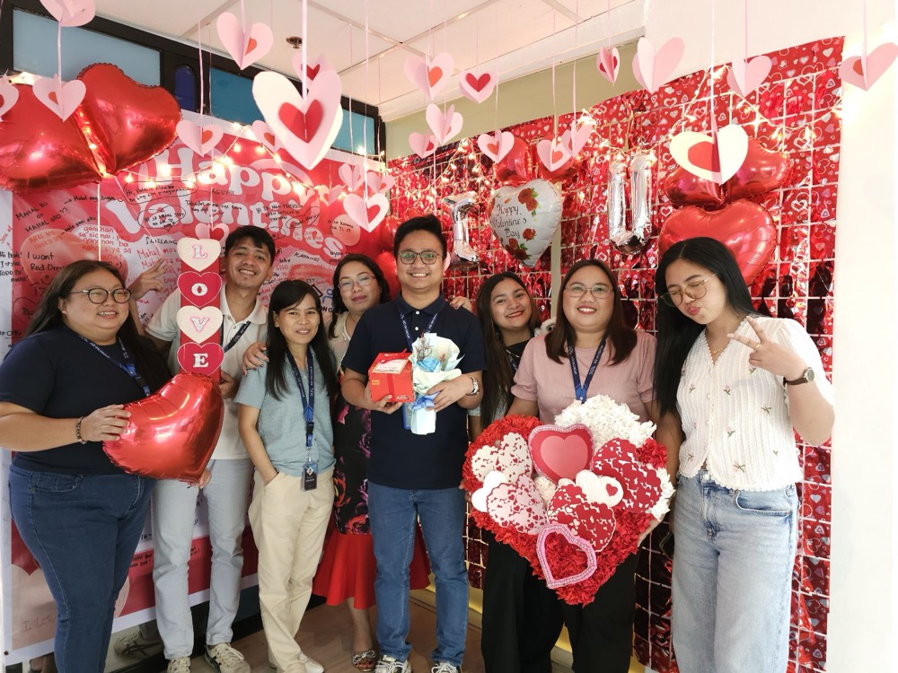 Team celebrating Valentine's Day in the office with decorations