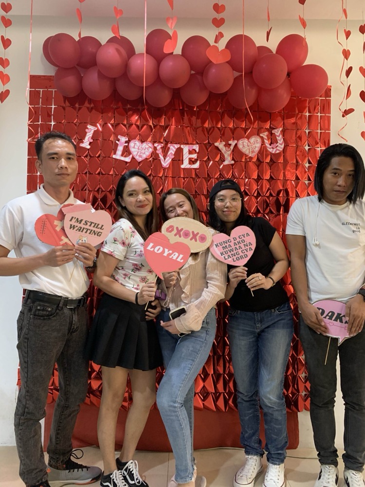 Team members posing with props at a company event