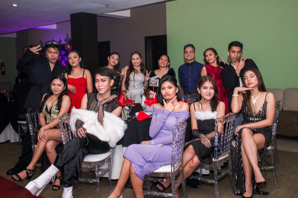 Colleagues seated together in evening wear at the staff party