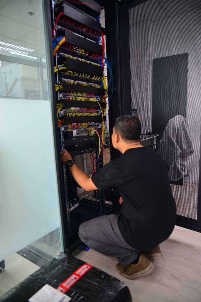Technician working on the office server rack