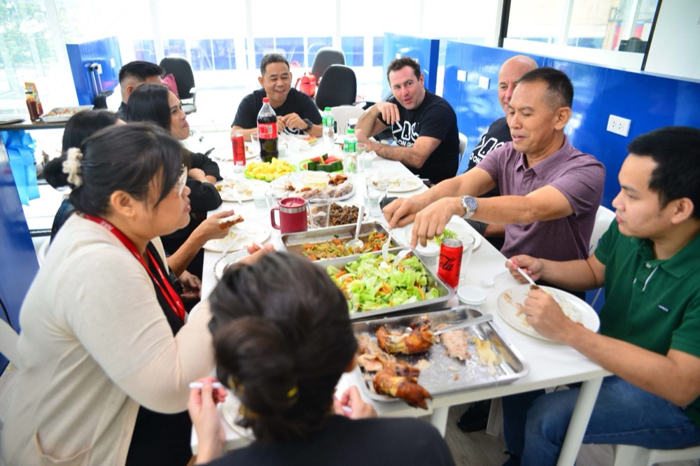 Staff sharing a catered lunch around a long table