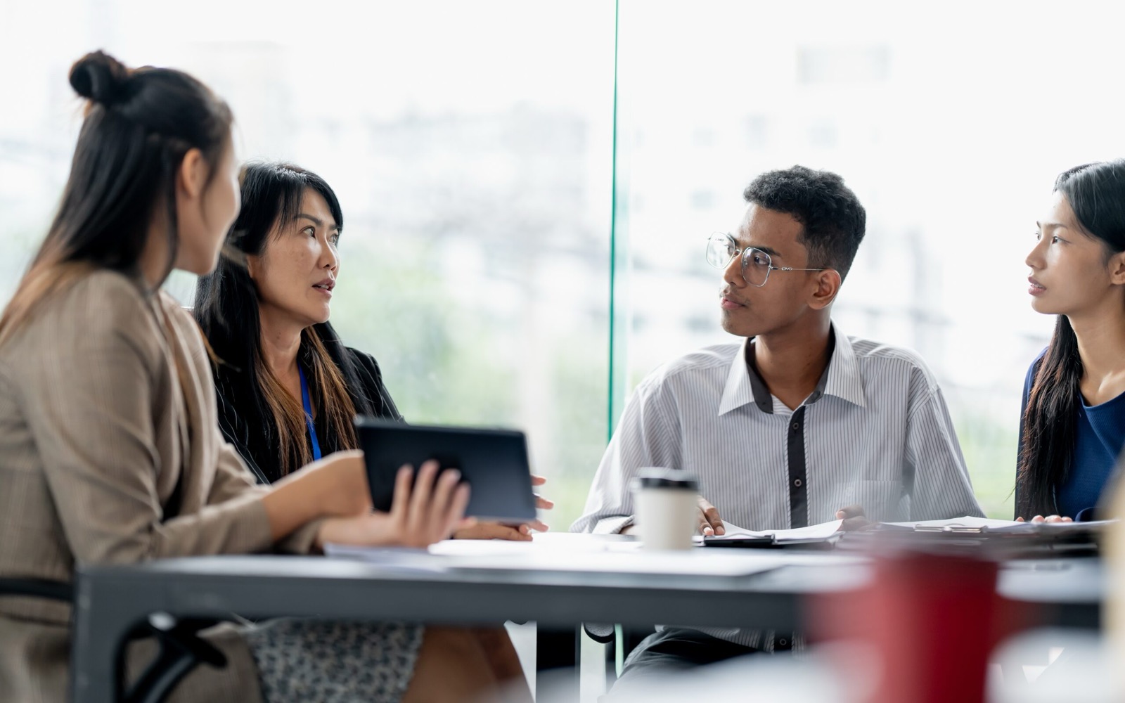 Colleagues in discussion around a meeting table