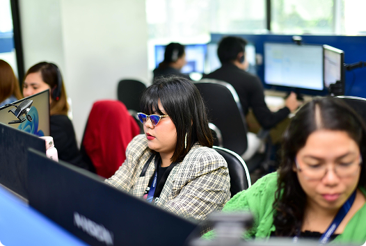 Ad On Group staff handling calls on the office floor
